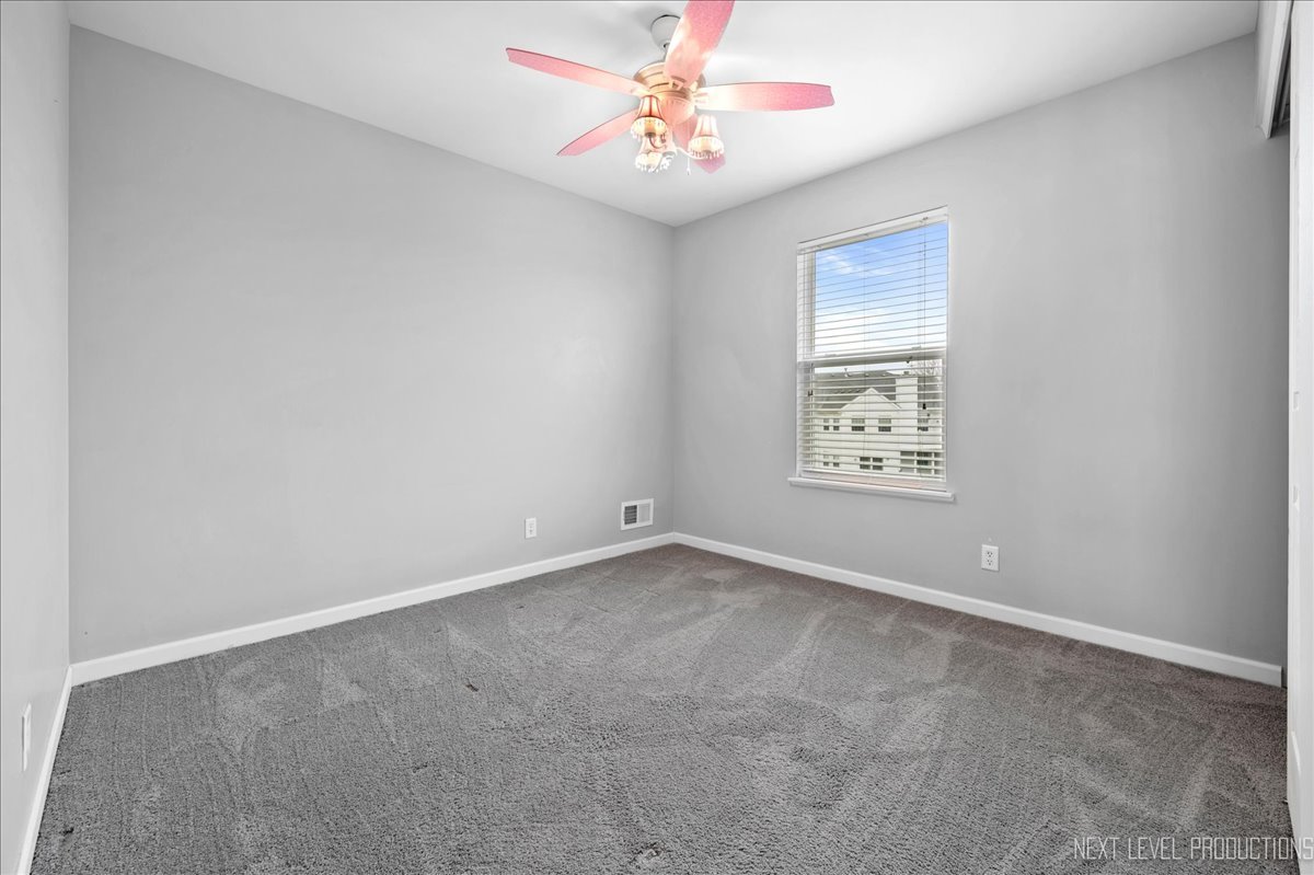 442 Windett Ridge Road Yorkville, IL 60560 - Photo 27 of 43 an empty room with windows and fan