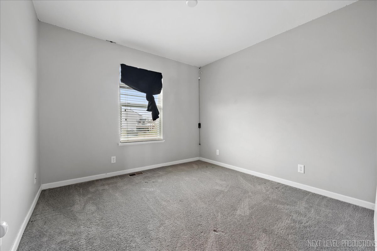 442 Windett Ridge Road Yorkville, IL 60560 - Photo 29 of 43 a view of an empty room with a window