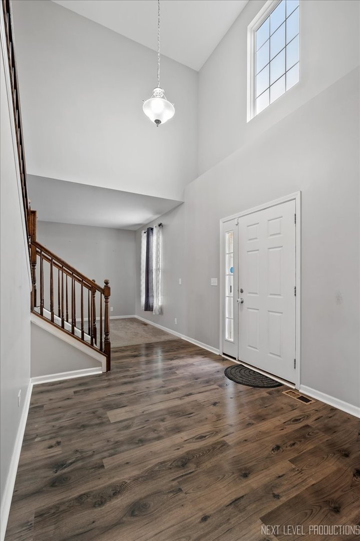 442 Windett Ridge Road Yorkville, IL 60560 - Photo 7 of 43 an empty room with wooden floor and windows