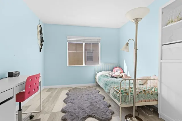 a bedroom with furniture and a window