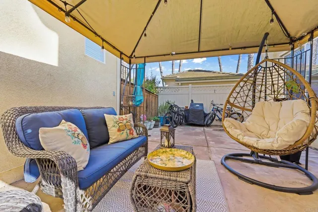 a living room with furniture a rug and white walls