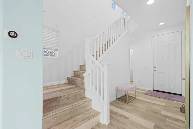 a view of entryway and hall with wooden floor