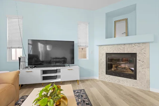 a living room with a fireplace and a flat screen tv