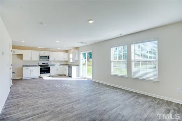 a large kitchen with a stove top oven and kitchen island