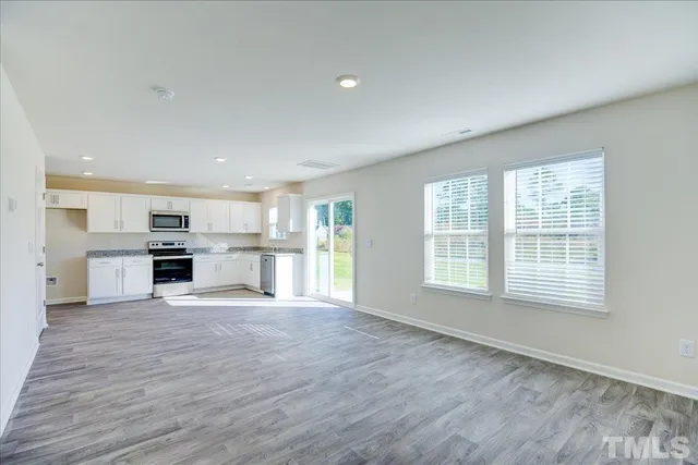 a large kitchen with a stove top oven and kitchen island