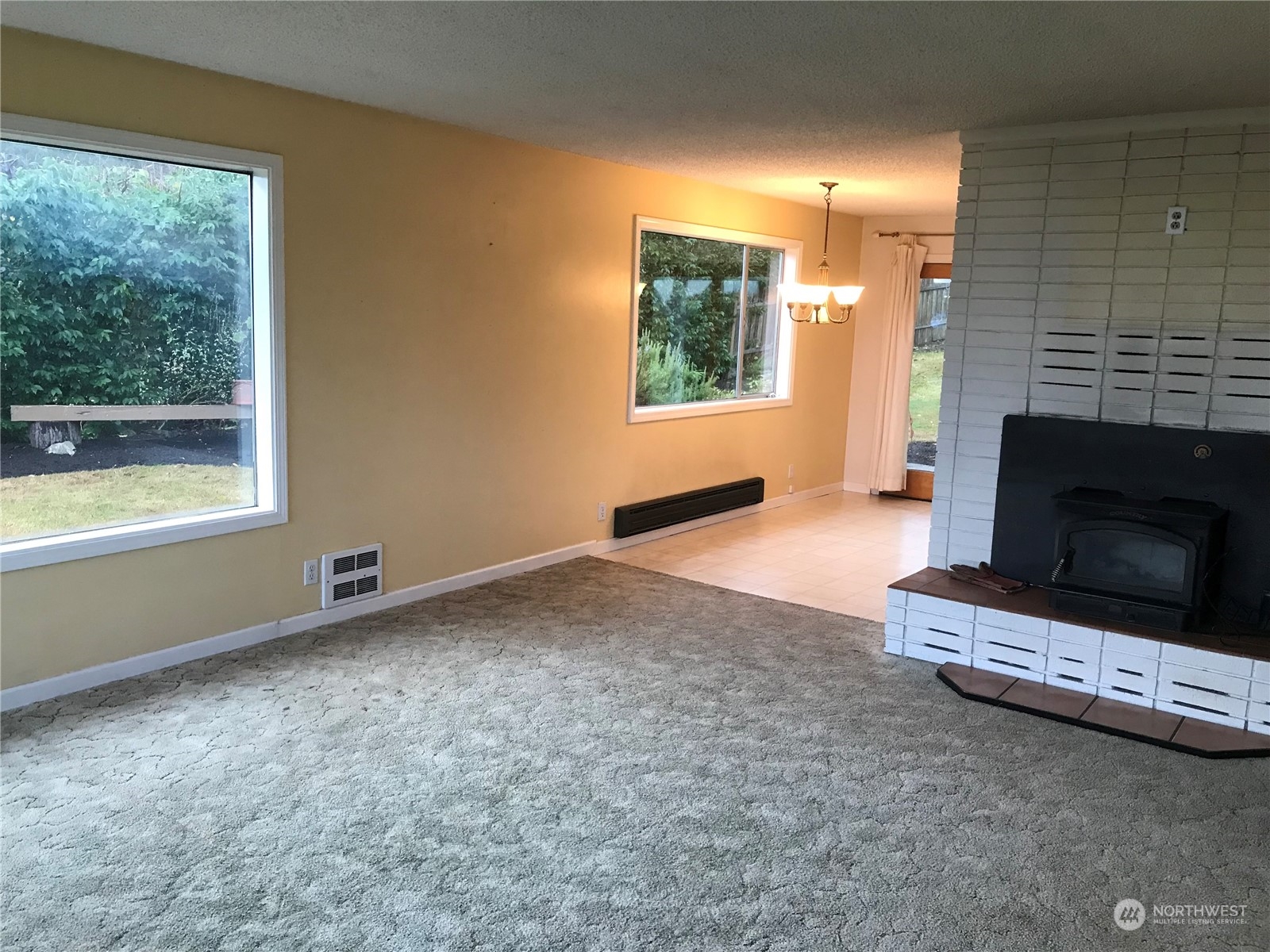 22817 Jefferson Point Road Northeast Kingston, WA 98346 - Photo 4 of 24 a view of an empty room with a fireplace and a window