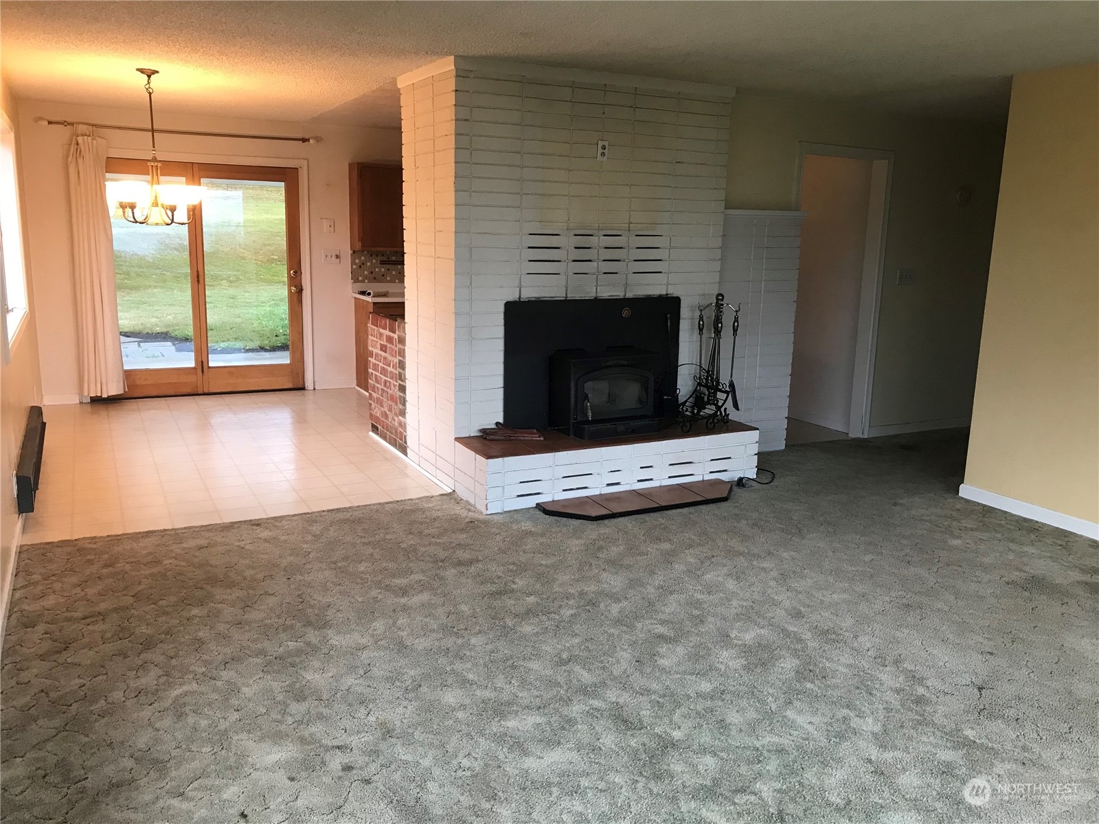 22817 Jefferson Point Road Northeast Kingston, WA 98346 - Photo 6 of 24 a view of empty room with fireplace and window