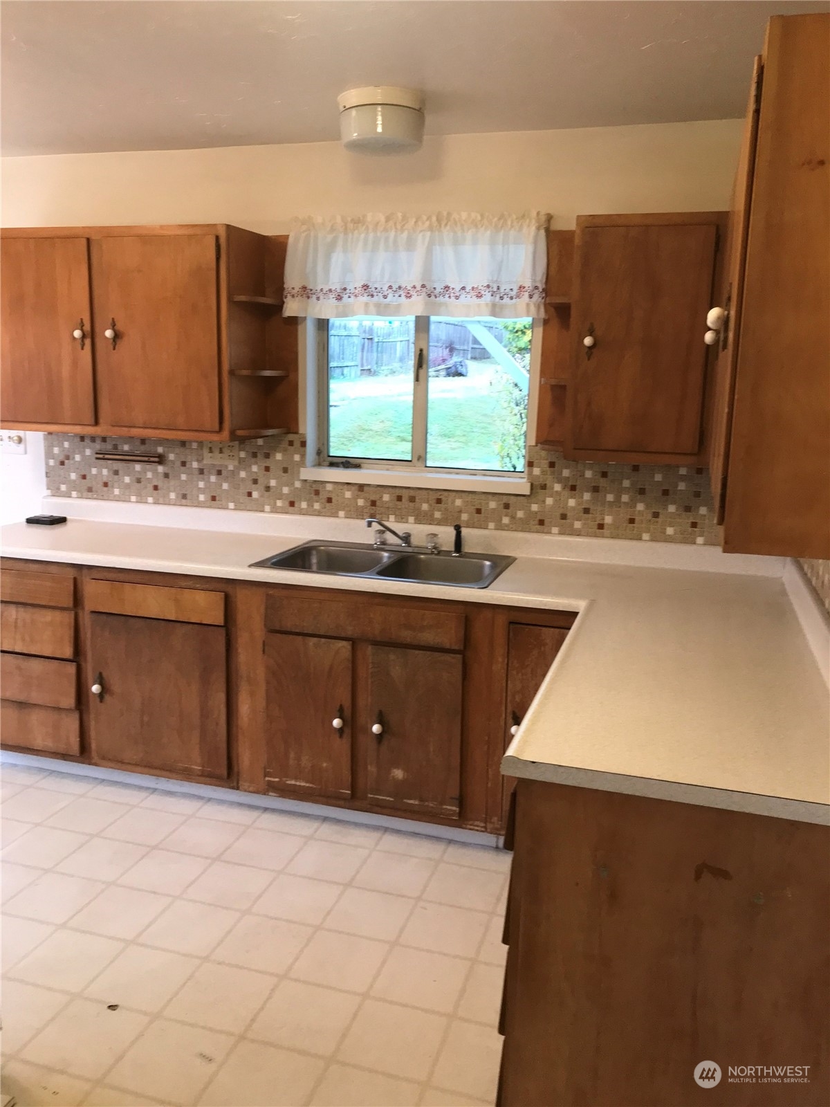 22817 Jefferson Point Road Northeast Kingston, WA 98346 - Photo 9 of 24 a kitchen with a sink stove and cabinets