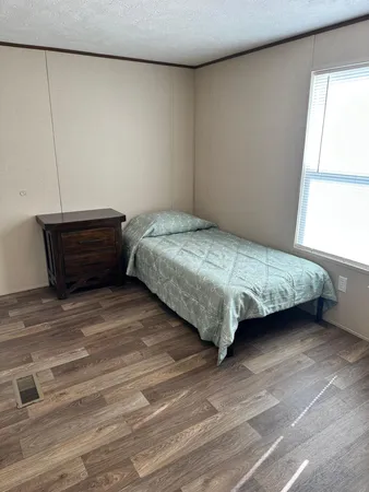 a bedroom with a bed and window