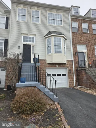 a front view of a house with large windows