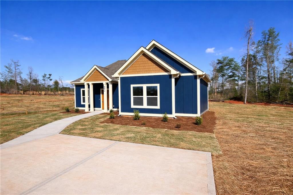 23 S Road Griffin, GA 30224 - Photo 3 of 32 a front view of a house with yard and trees in the background