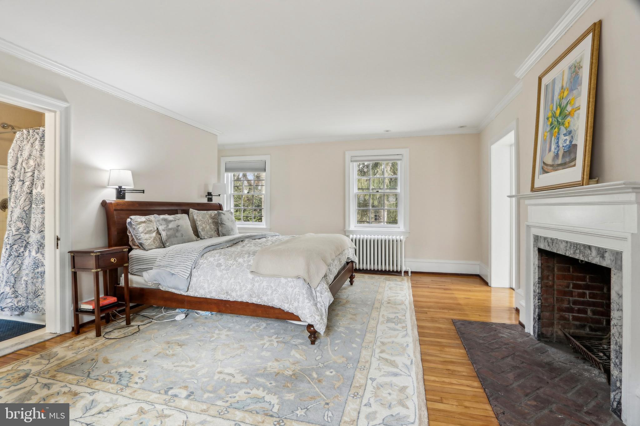 311 Kent Road Wynnewood, PA 19096 - Photo 54 of 117 a spacious bedroom with a large bed and a fireplace