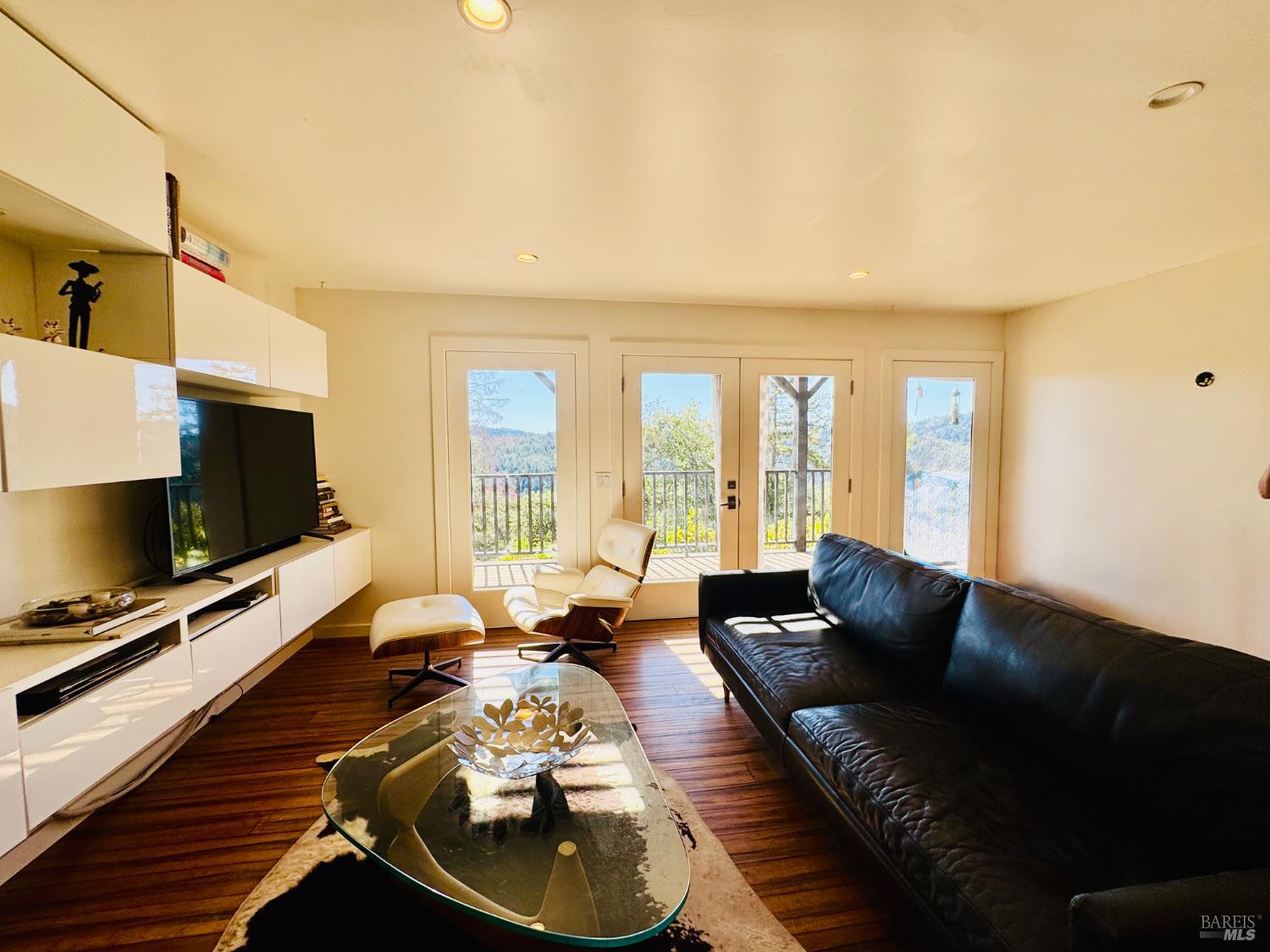 18574 Tomki Road Willits, CA 95490 - Photo 2 of 25 a living room with furniture a flat screen tv and a large window