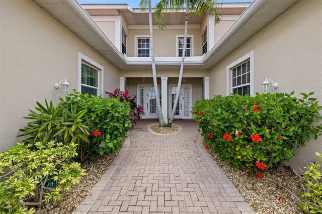 a view of a house with potted plants