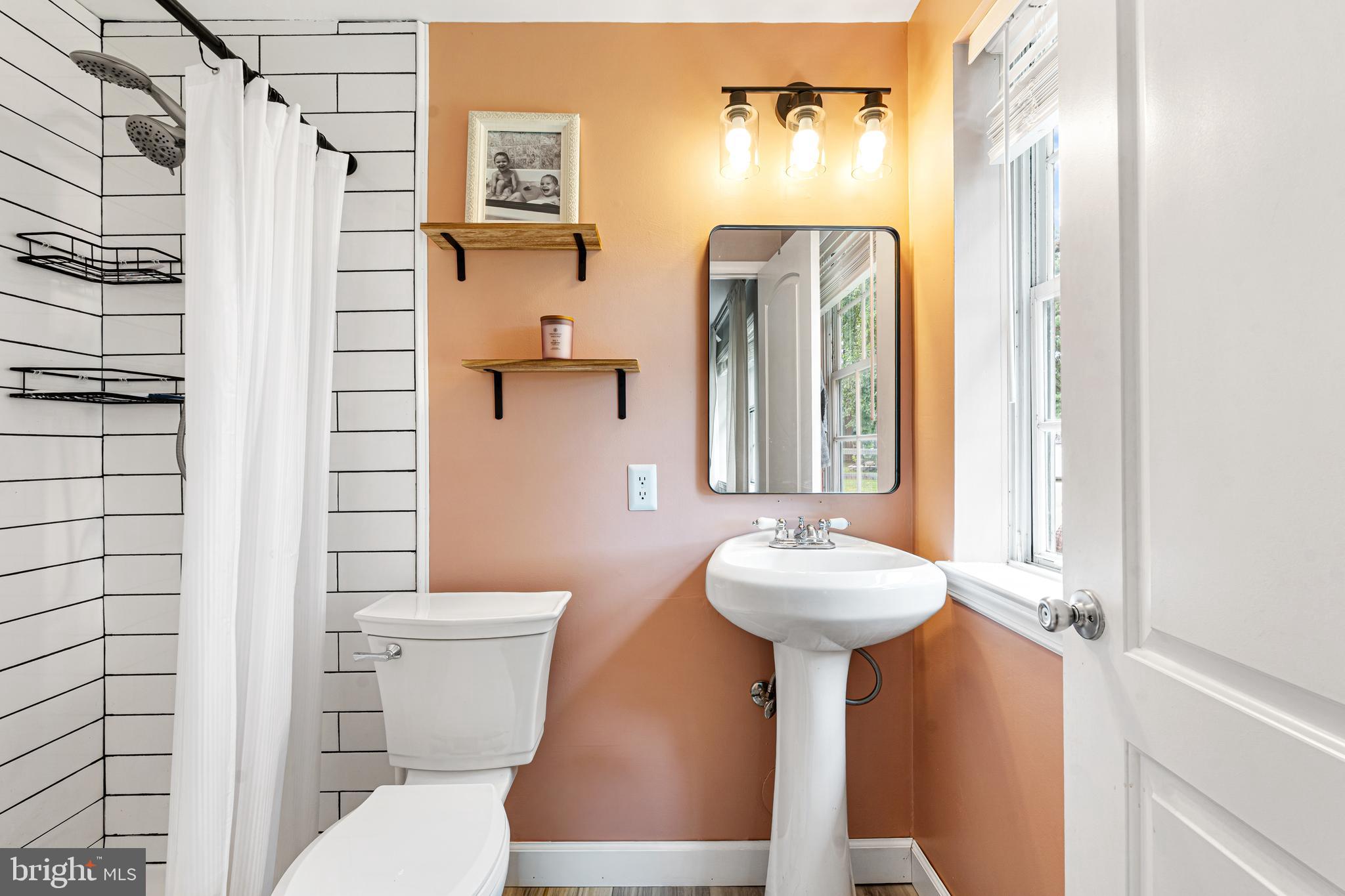 2423 Lodge Farm Road Sparrows Point, MD 21219 - Photo 21 of 29 a bathroom with a sink a toilet and shower