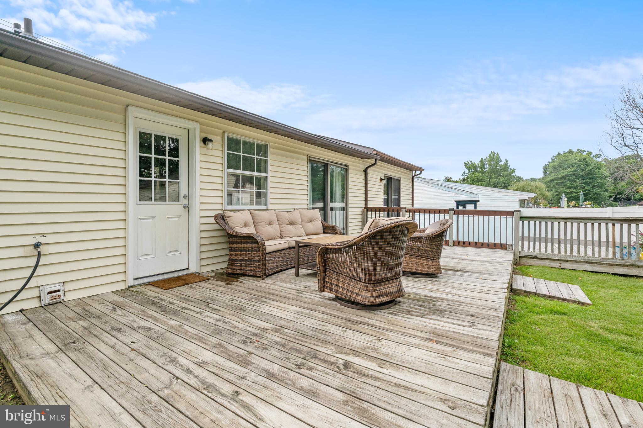 2423 Lodge Farm Road Sparrows Point, MD 21219 - Photo 3 of 29 a balcony of a house with wooden floor outdoor seating and yard in the back