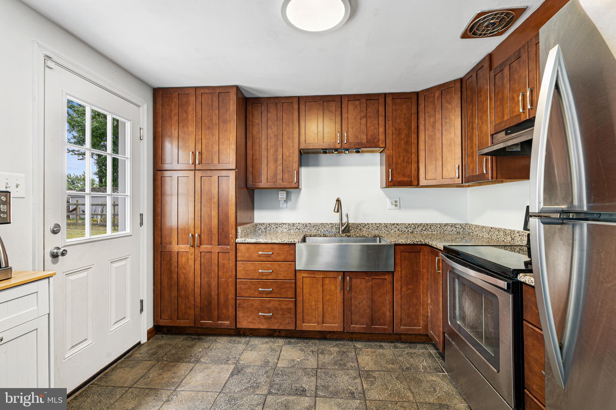 2423 Lodge Farm Road Sparrows Point, MD 21219 - Photo 8 of 29 a kitchen with stainless steel appliances granite countertop a refrigerator sink and cabinets