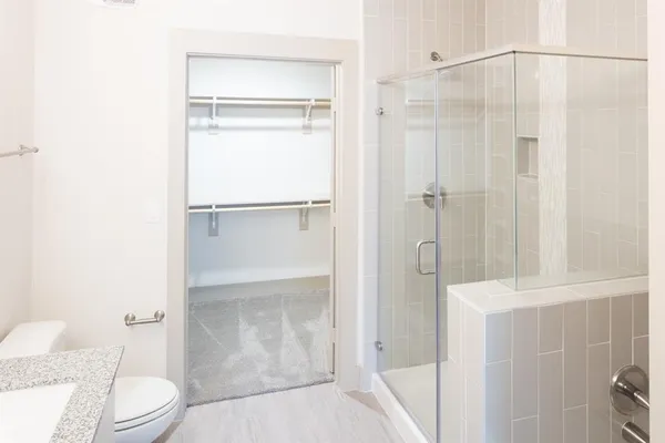 a bathroom with a shower and a toilet