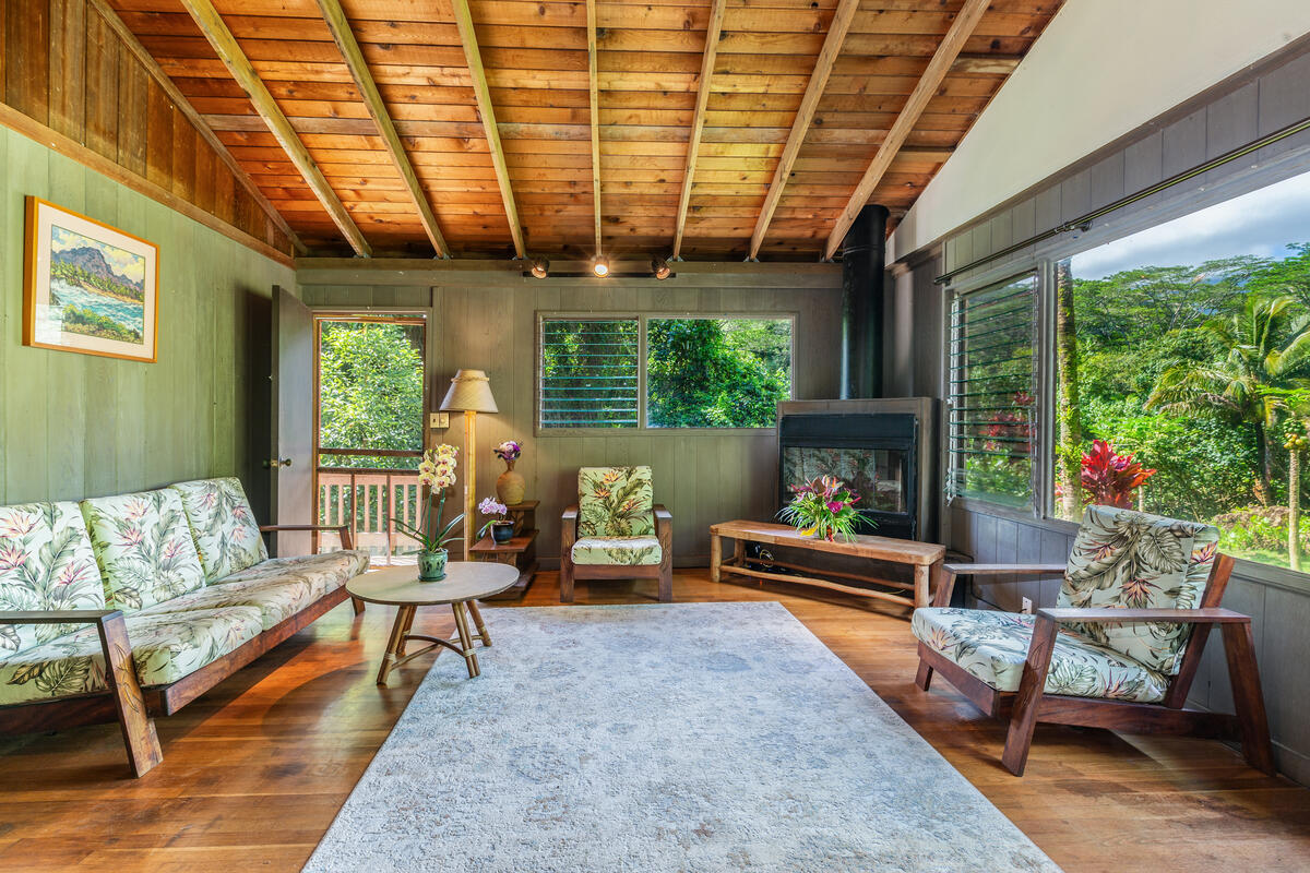4867 Wainiha Powerhouse Road Hanalei, HI 96714 - Photo 7 of 26 a living room with patio furniture and a fireplace