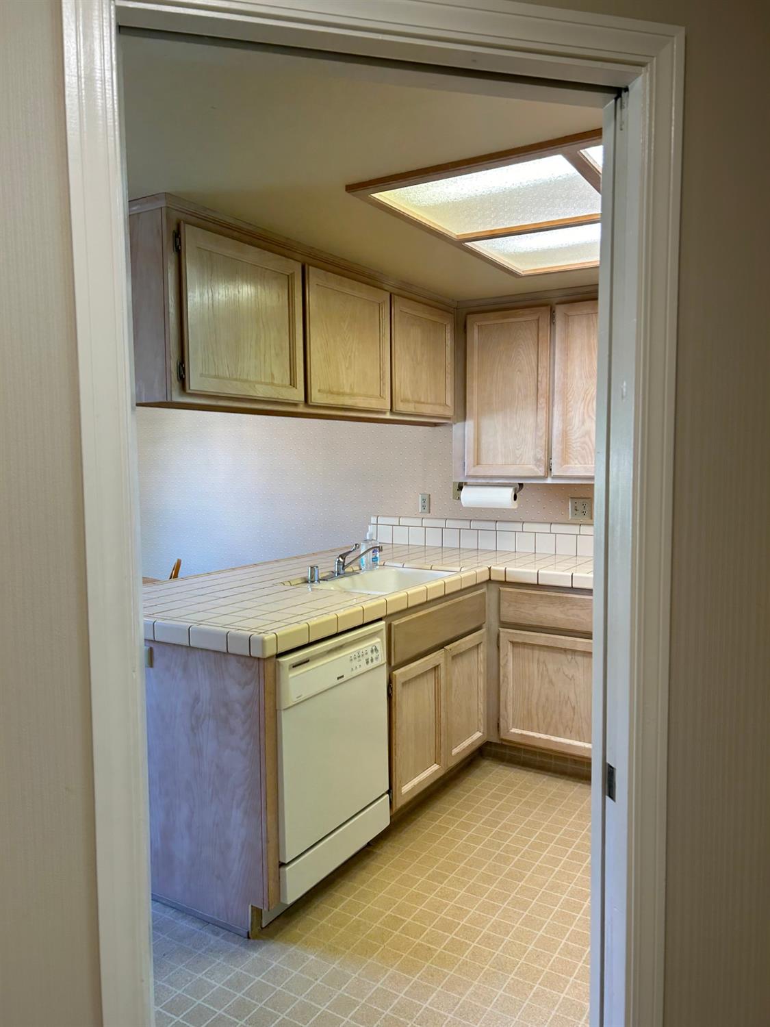 1067 Rio Cidade Way Sacramento, CA 95831 - Photo 11 of 33 a kitchen with a sink cabinets and a window