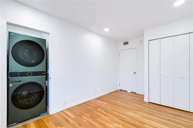 a view of a bedroom with washer and dryer