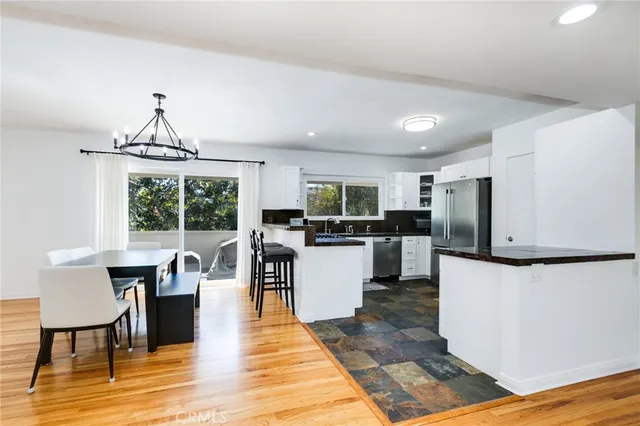 a living room with stainless steel appliances kitchen island granite countertop furniture a dining table and chairs