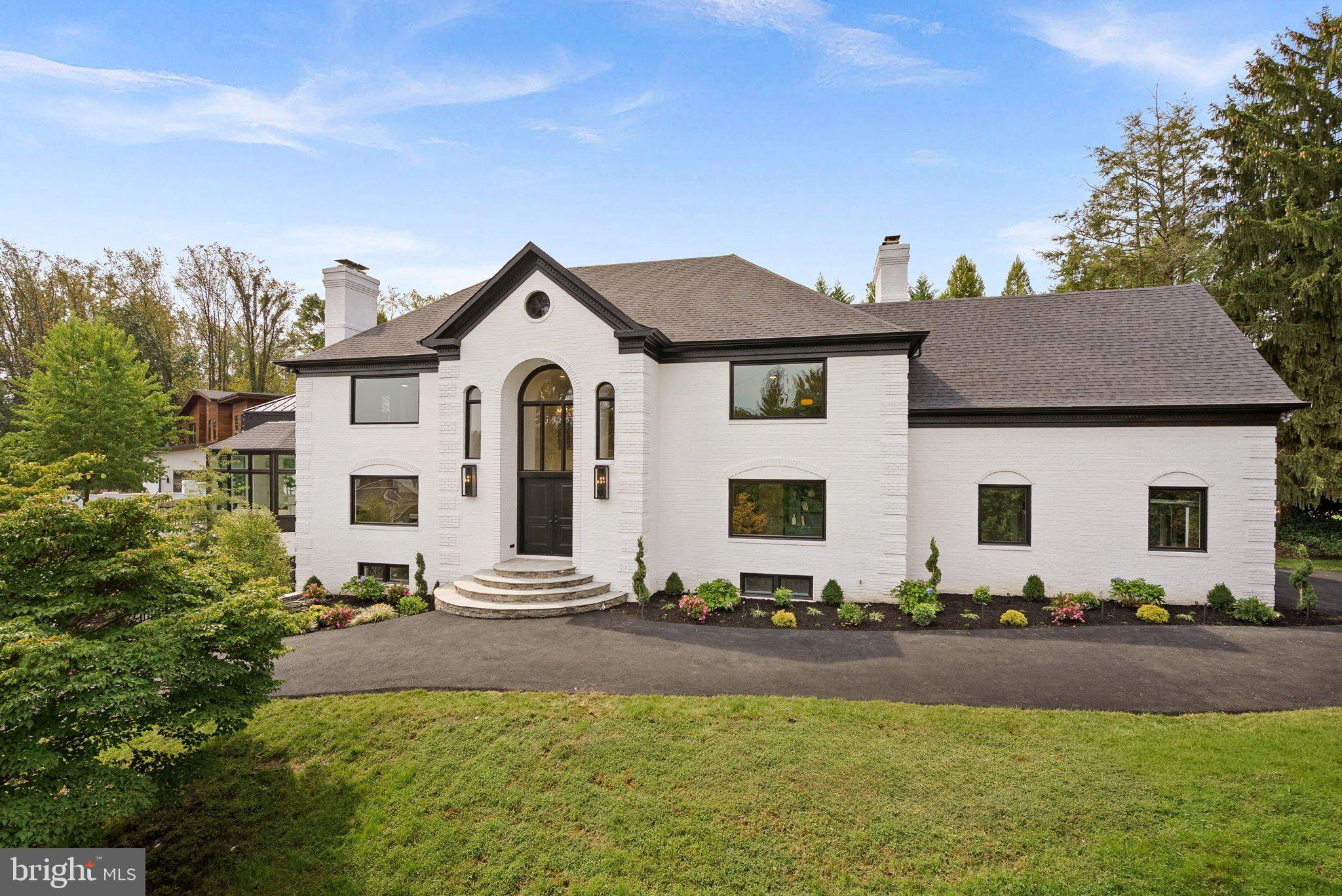 6121 Long Meadow Road McLean, VA 22101 - Photo 1 of 5 a front view of house with yard and trees in the background