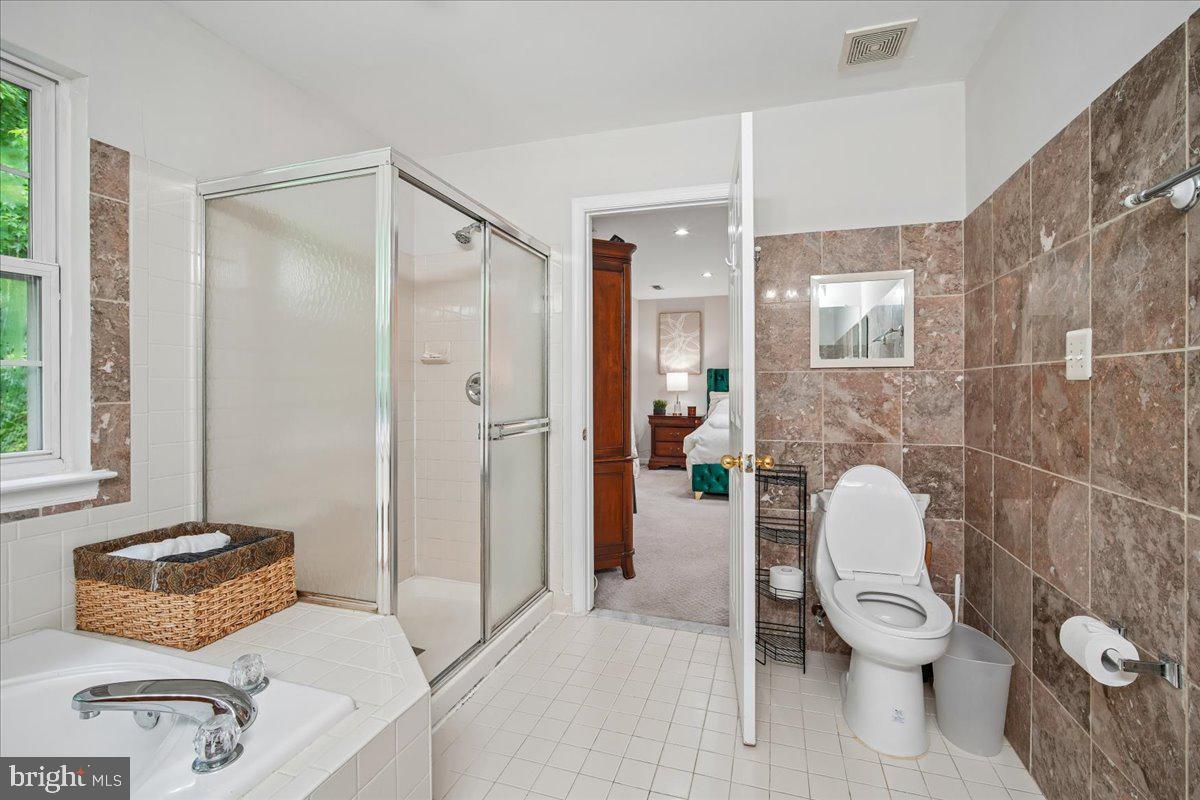 1112 Ryon Way District Heights, MD 20747 - Photo 29 of 63 a bathroom with a granite countertop toilet sink and shower