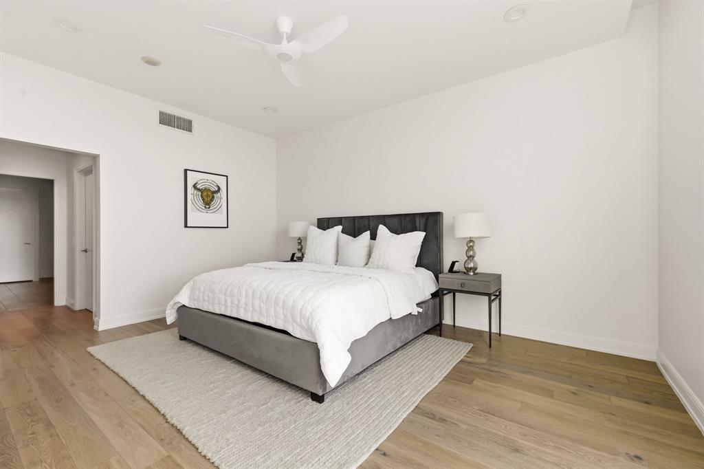 5656 North Central Expressway, Unit 801 Dallas, TX 75206 - Photo 12 of 26 a bedroom with a bed and a night stand