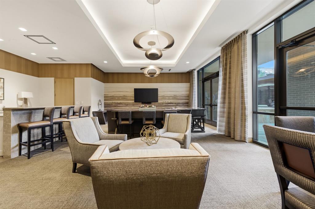 5656 North Central Expressway, Unit 801 Dallas, TX 75206 - Photo 22 of 26 a living room with couches a flat screen tv and kitchen view