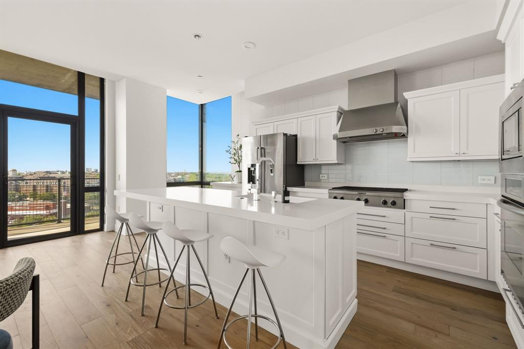 5656 North Central Expressway, Unit 801 Dallas, TX 75206 - Photo 7 of 26 a kitchen with stainless steel appliances kitchen island granite countertop a stove a sink and a refrigerator