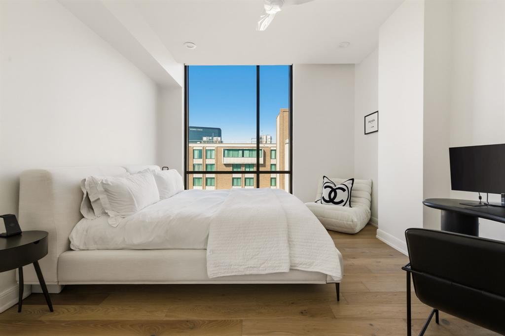 5656 North Central Expressway, Unit 801 Dallas, TX 75206 - Photo 10 of 26 a bedroom with a bed and a flat screen tv