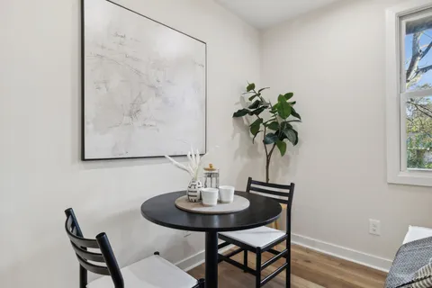 a view of a dining room with furniture and a potted plant