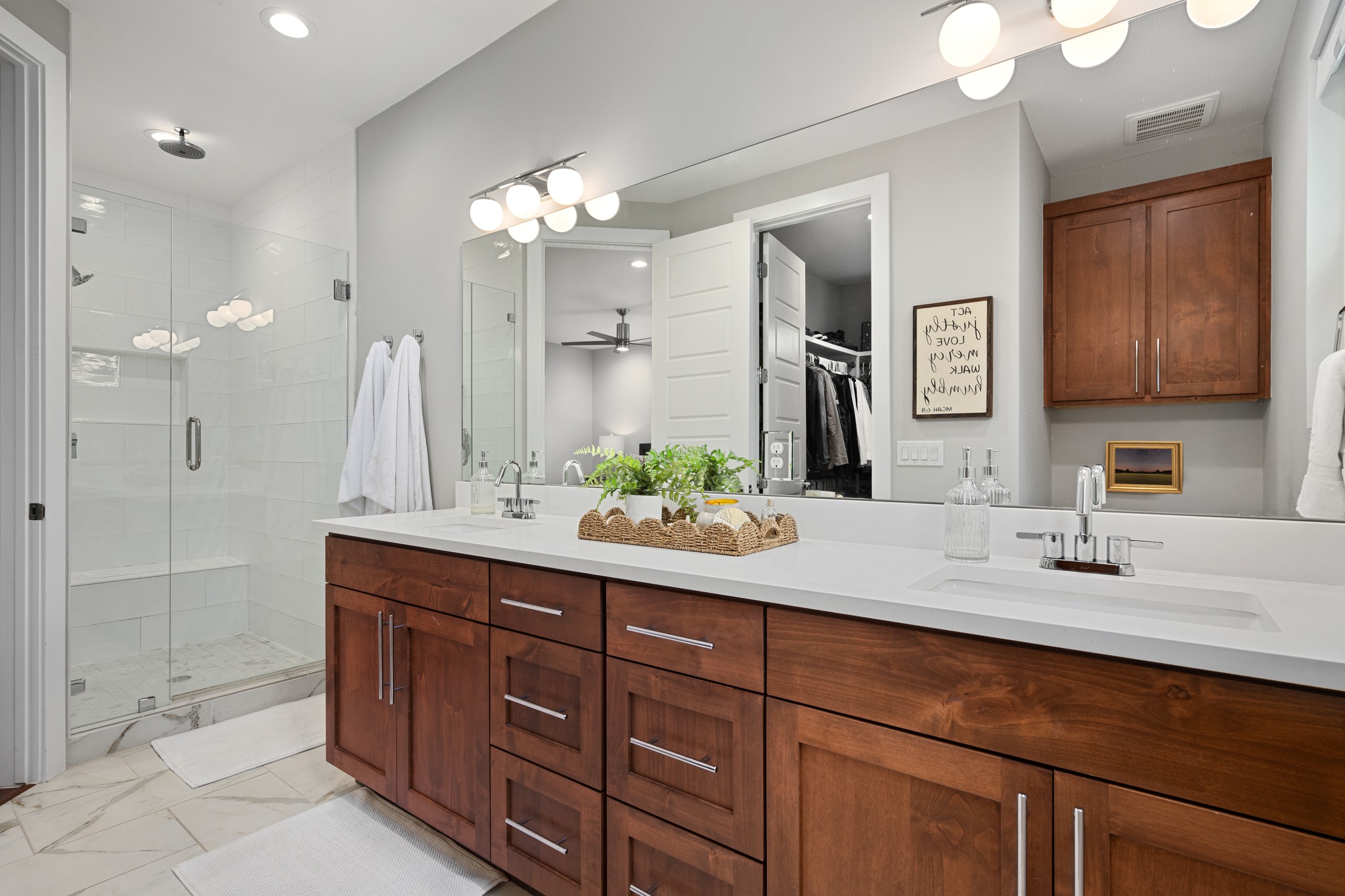 1103 Saucedo Street, Unit 1 Austin, TX 78721 - Photo 31 of 40 Dual vanities and a spacious glass shower create a refreshing and functional bathroom.