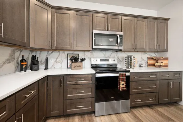 a kitchen with a sink a stove and cabinets