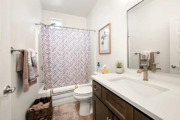 a view of a kitchen with fridge and wooden floor