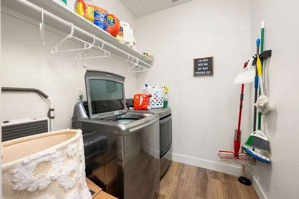 a bedroom with a bed painting on wall and a large window