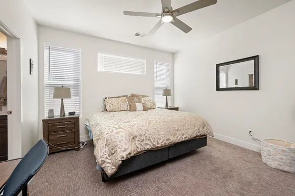 a bedroom with a bed a dresser and chair