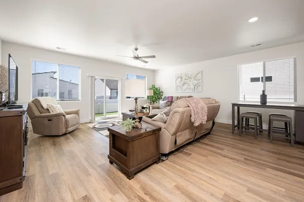 a living room with furniture and a wooden floor