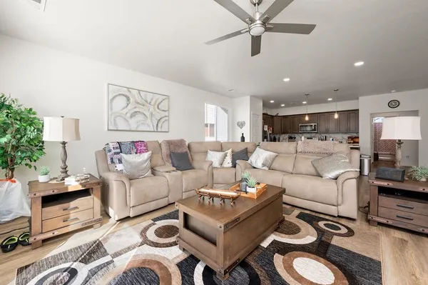a living room with furniture and a view of kitchen