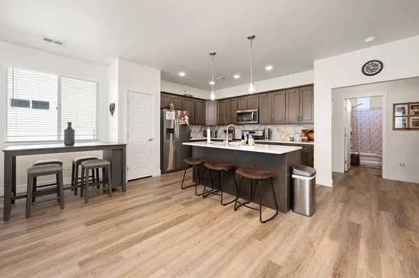 a living room with furniture a large window and a flat screen tv