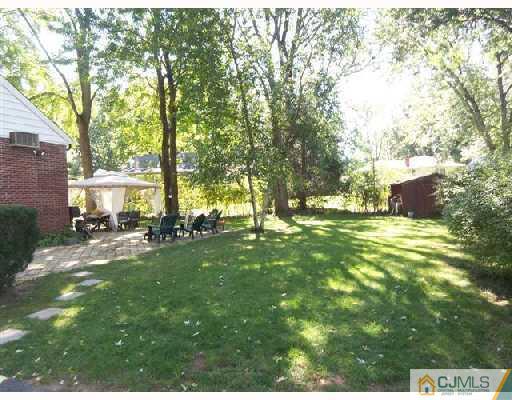 15 Morningside Road Colonia, NJ 07067 - Photo 2 of 8 a view of yard with swimming pool and trees