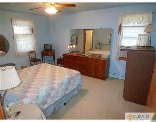 15 Morningside Road Colonia, NJ 07067 - Photo 7 of 8 a spacious bedroom with a bed and window