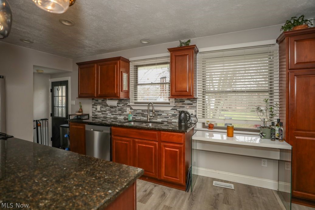 10676 Holcomb Road Newton Falls, OH 44444 - Photo 20 of 38 Kitchen with dark granite counters and decorative blacksplash
