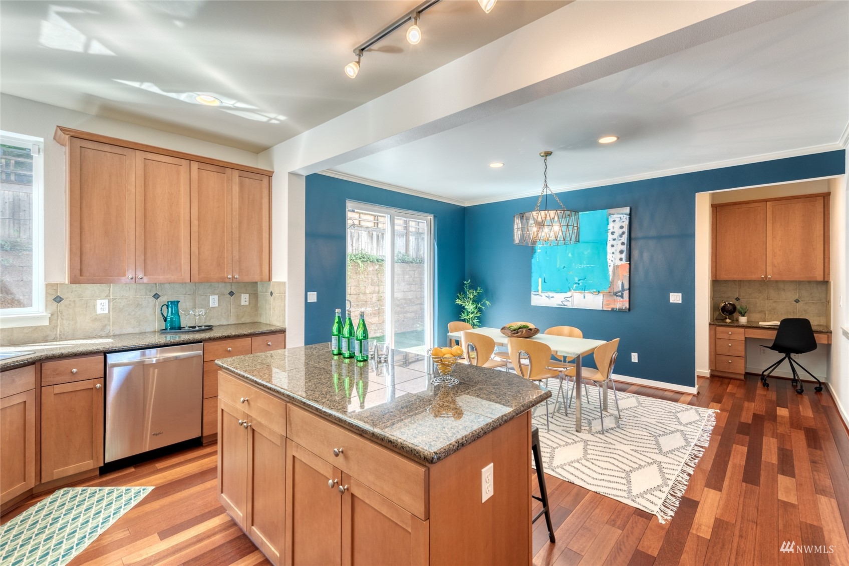 569 Alpine Ridge Place Northwest Issaquah, WA 98027 - Photo 15 of 35 a kitchen with stainless steel appliances granite countertop a stove top oven a sink dishwasher and cabinets with wooden floor