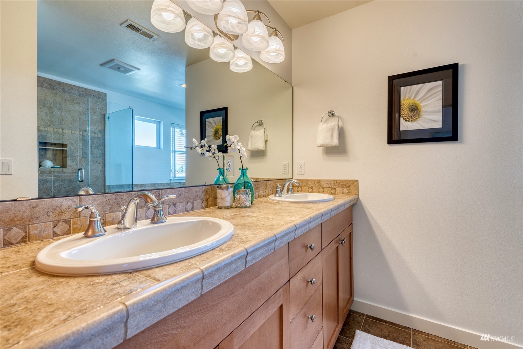 569 Alpine Ridge Place Northwest Issaquah, WA 98027 - Photo 20 of 35 a bathroom with a granite countertop sink a large mirror and vanity