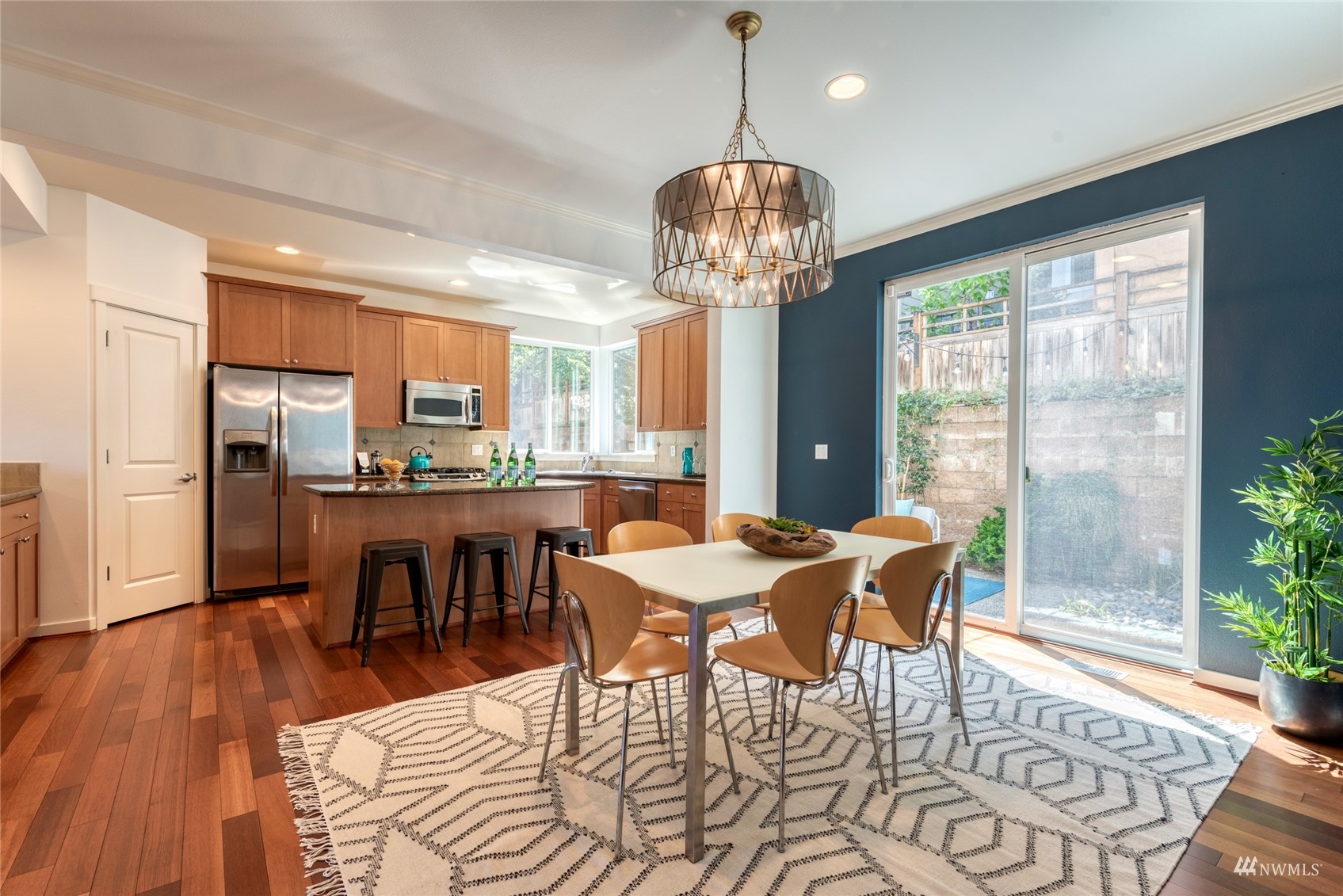 569 Alpine Ridge Place Northwest Issaquah, WA 98027 - Photo 9 of 35 a view of a dining room with furniture wooden floor and chandelier