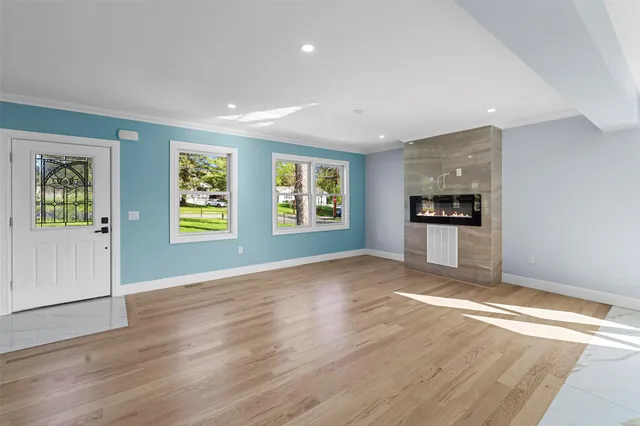 a view of empty room with kitchen and window