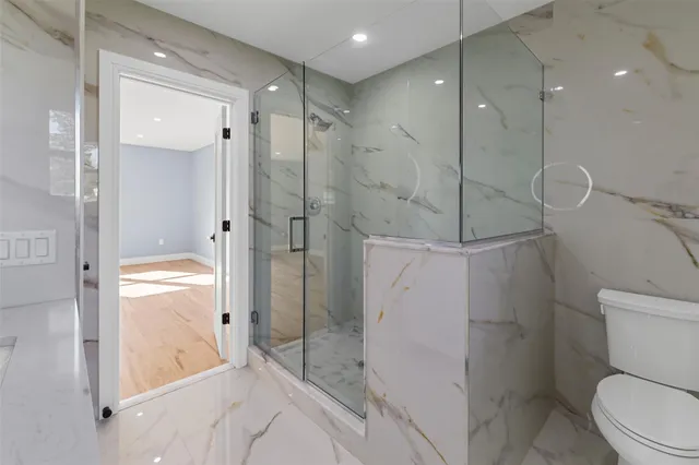 a bathroom with a shower a toilet and a sink