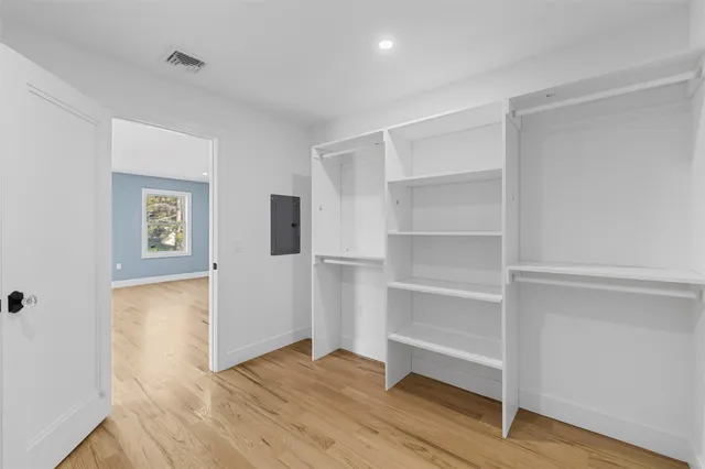 a view of a room with wooden floor and closet